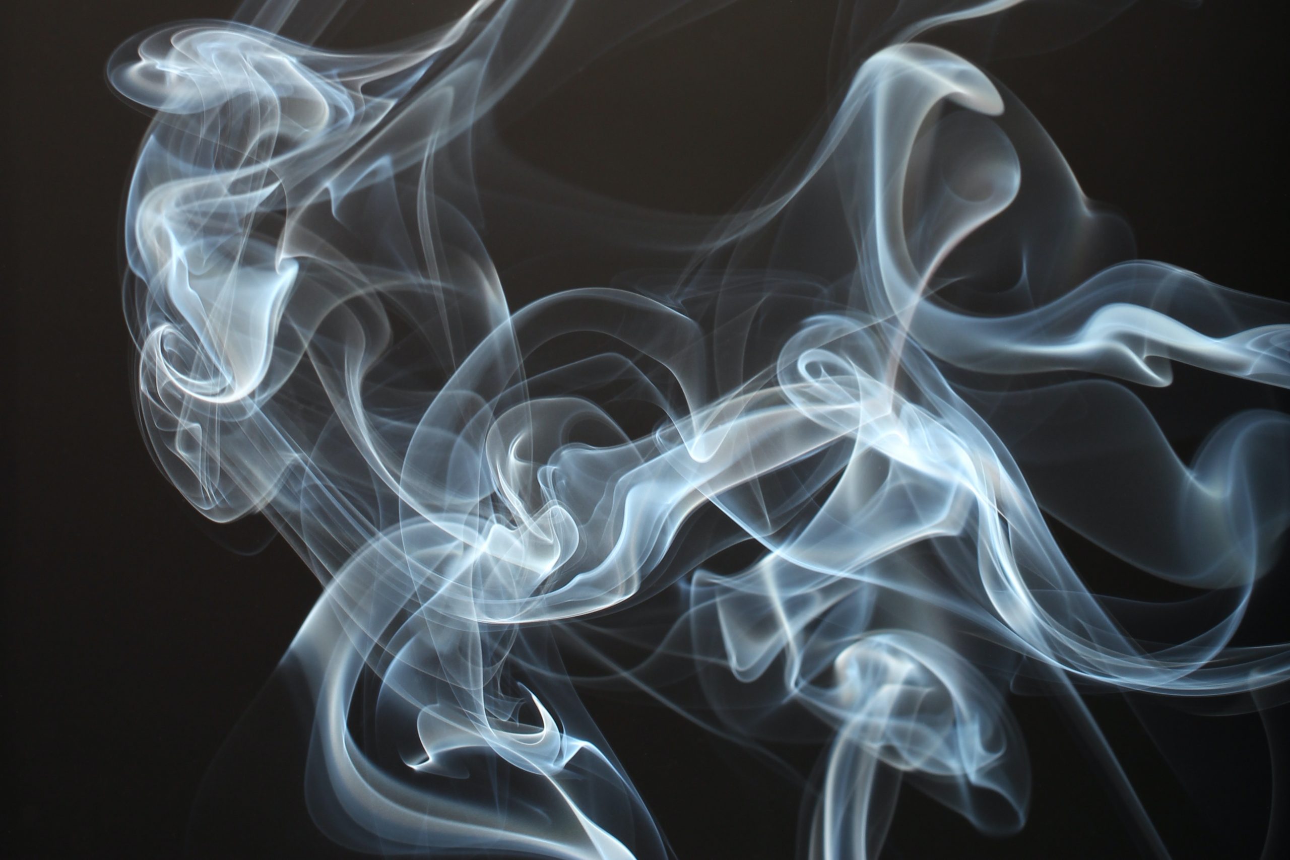 blue-grey smoke wisps on a black background